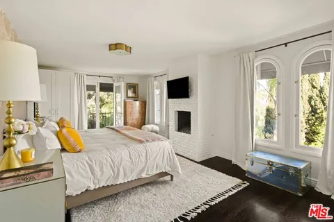 a bedroom with a bed and a television