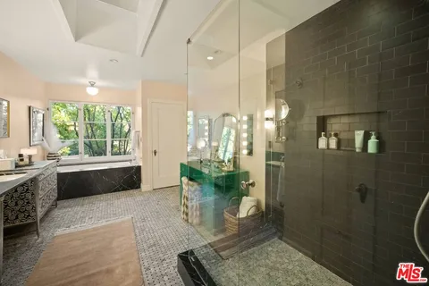 a view of a swimming pool with lawn chairs under an umbrella