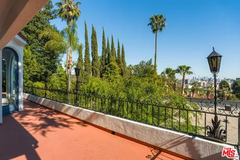 a living room with furniture large window and table