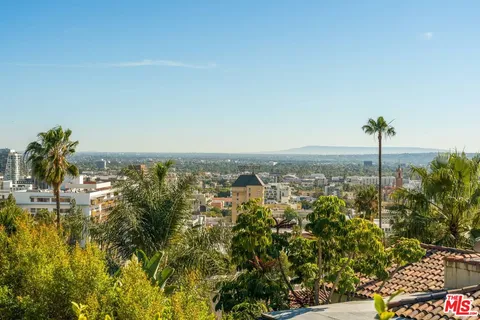 a kitchen with stainless steel appliances granite countertop a stove a sink dishwasher and a refrigerator