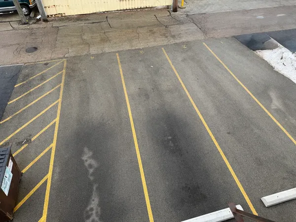 a view of a building with car parked