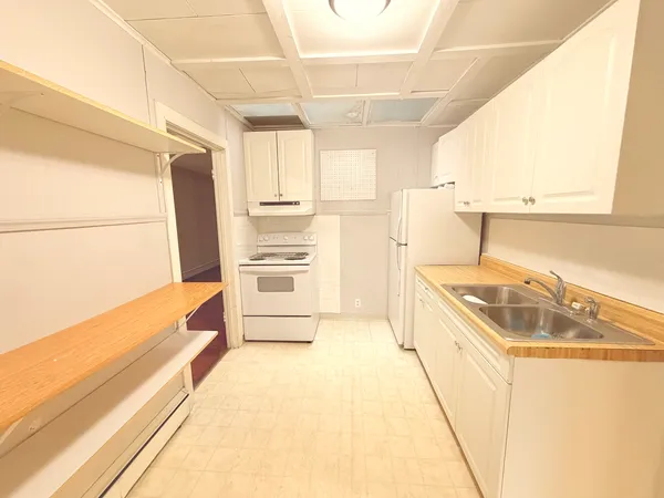 a kitchen with a refrigerator and a sink