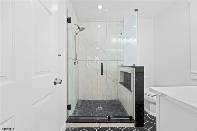 a backyard of a house with large trees and outdoor seating