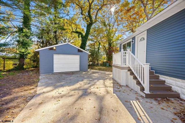 a kitchen with a sink white cabinets and white appliances