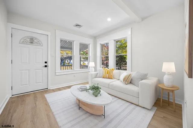 an empty room with a window and a ceiling fan
