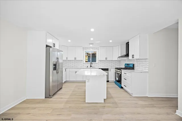 a bathroom with a toilet a sink a vanity and mirror