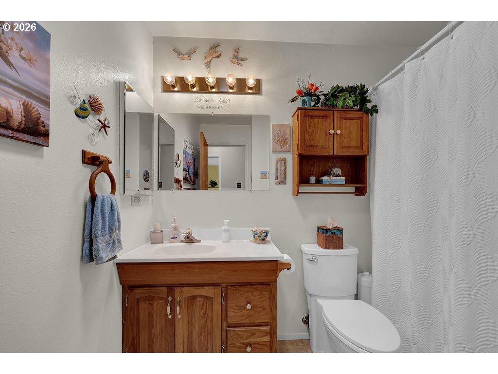 1415 20th Street Florence, OR 97439 - Photo 13 of 40 a bathroom with a sink and a mirror