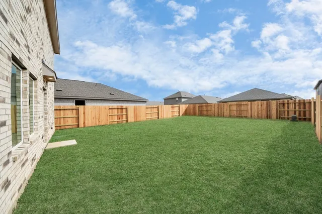 a view of an house with backyard space and balcony