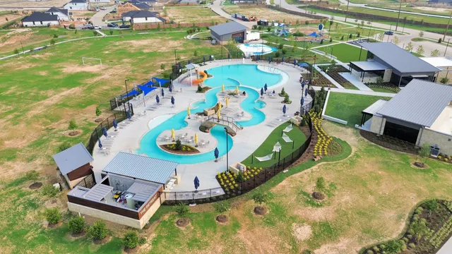 an aerial view of a houses with swimming pool