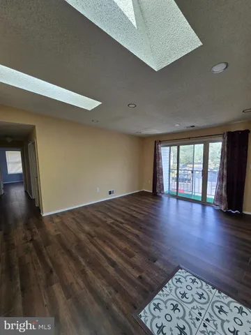 a view of room with window and wooden floor