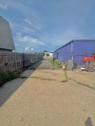 a view of street with wooden fence