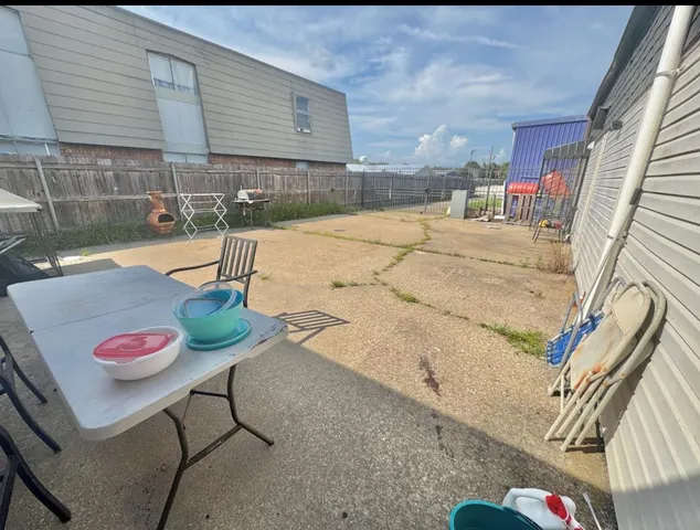 a view of a patio with table and chairs