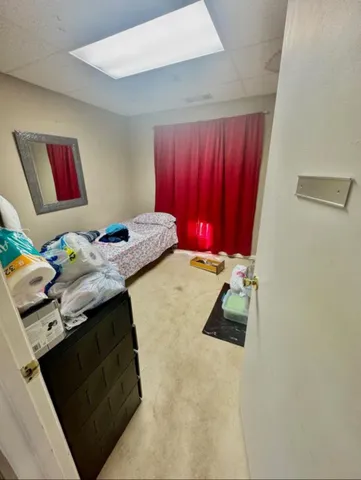 a bedroom with a bed and a dresser in it