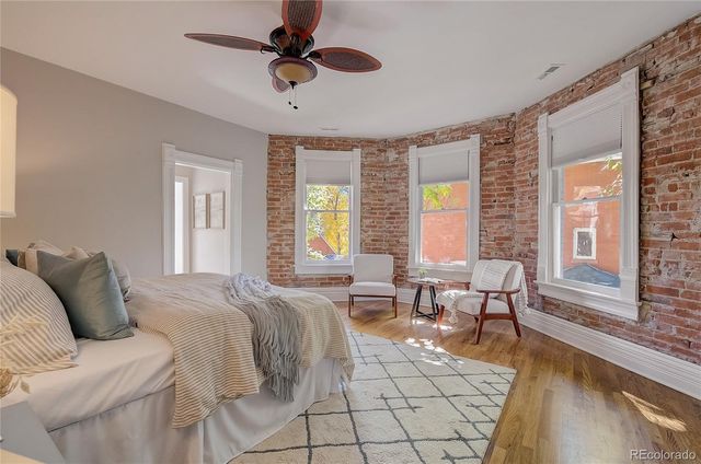 a bedroom with furniture and a large window