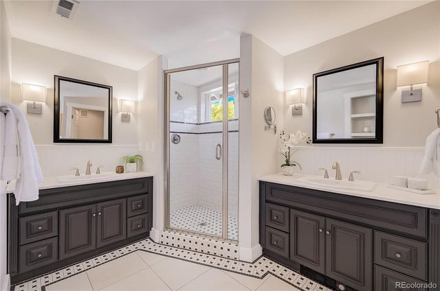 a bathroom with a double vanity sink and mirror