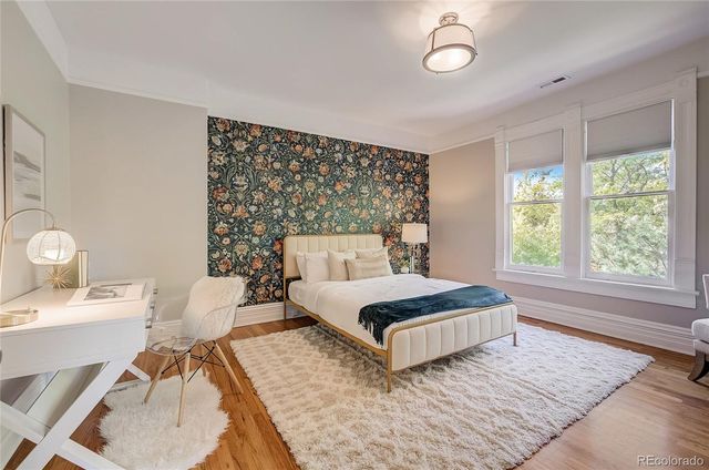 a living room with a bed furniture and a large window