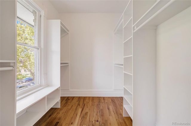a view of bathroom with window and wooden floor