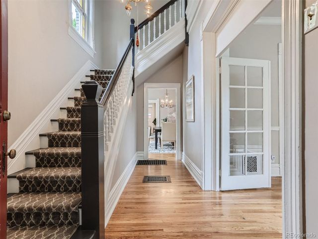 a view of a hallway with wooden floor and entryway