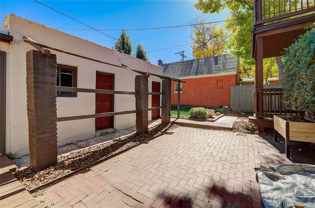a view of backyard with a large tree