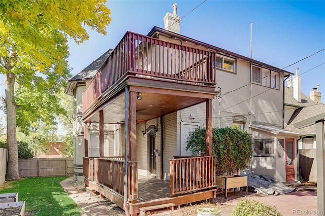 a view of a house with wooden fence