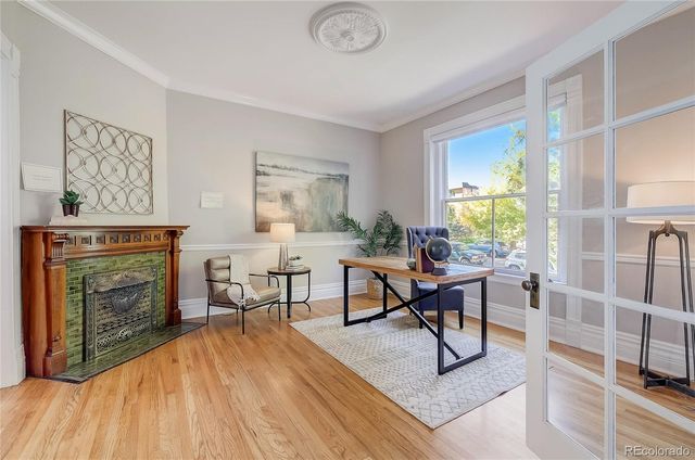 a living room with furniture a fireplace and a table