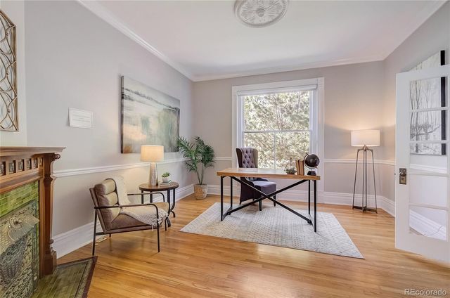 a living room with furniture a dining table and a window