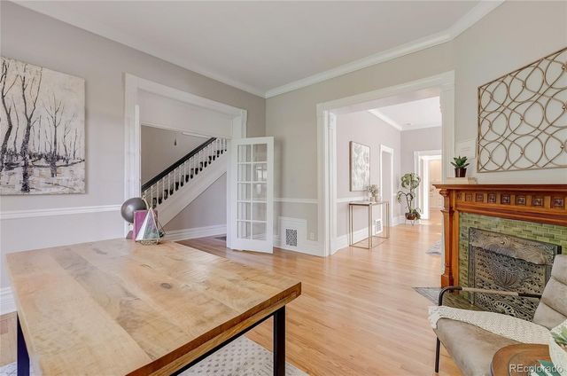a living room with wooden floor and furniture