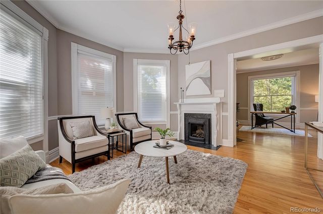 a living room with furniture fireplace and window