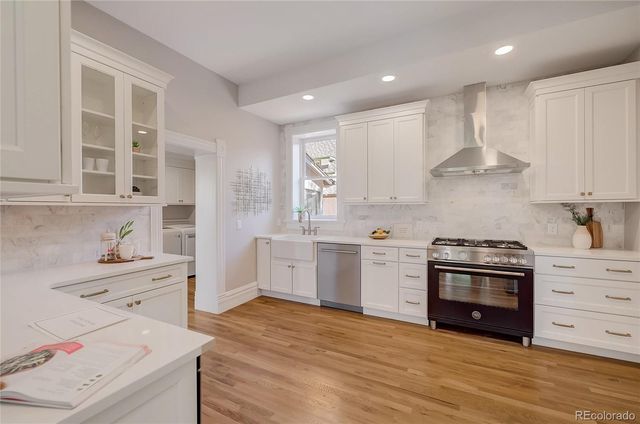 a kitchen with a stove oven and a sink