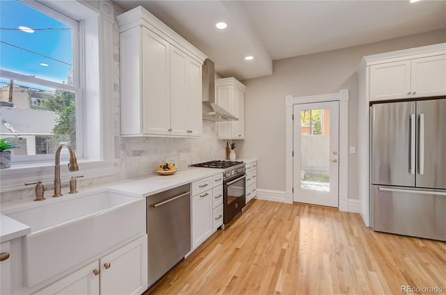 a kitchen with white cabinets and white appliances