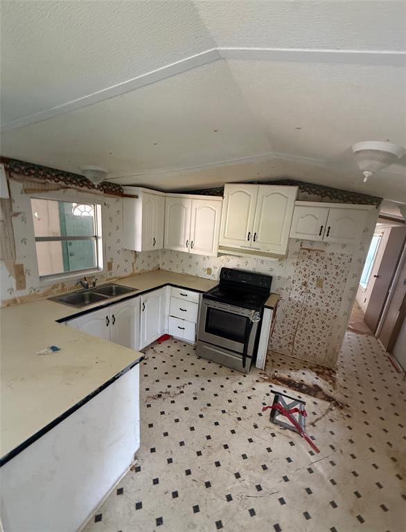 104 Lilly Street Kosse, TX 76653 - Photo 14 of 15 a kitchen with granite countertop a sink a stove a oven a dining table and chairs