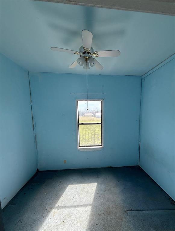 104 Lilly Street Kosse, TX 76653 - Photo 7 of 15 an empty room with a window and a ceiling fan