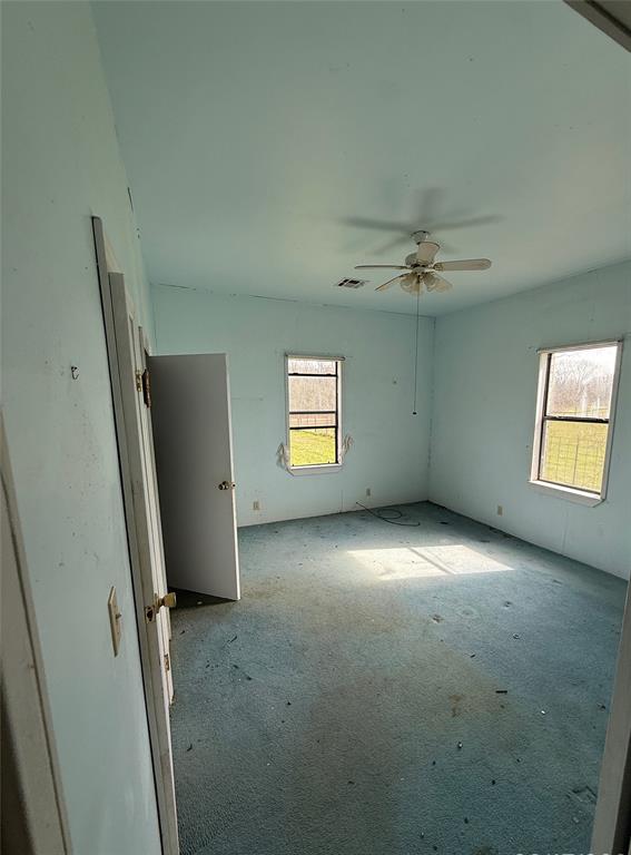 104 Lilly Street Kosse, TX 76653 - Photo 8 of 15 an empty room with windows and closet