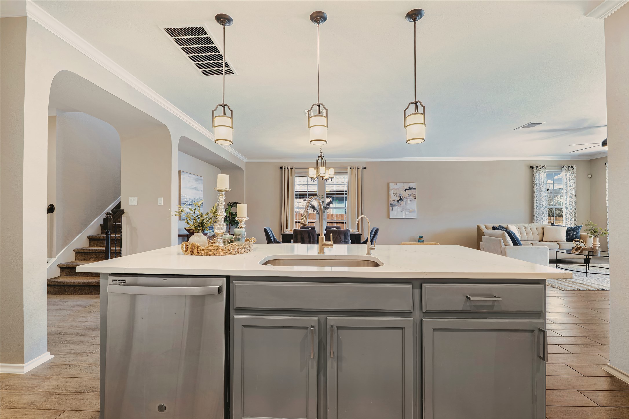 207 Telluride Drive Georgetown, TX 78626 - Photo 39 of 40 Kitchen with open floor plan, crown molding, gray cabinets, dishwasher, and a kitchen island with sink