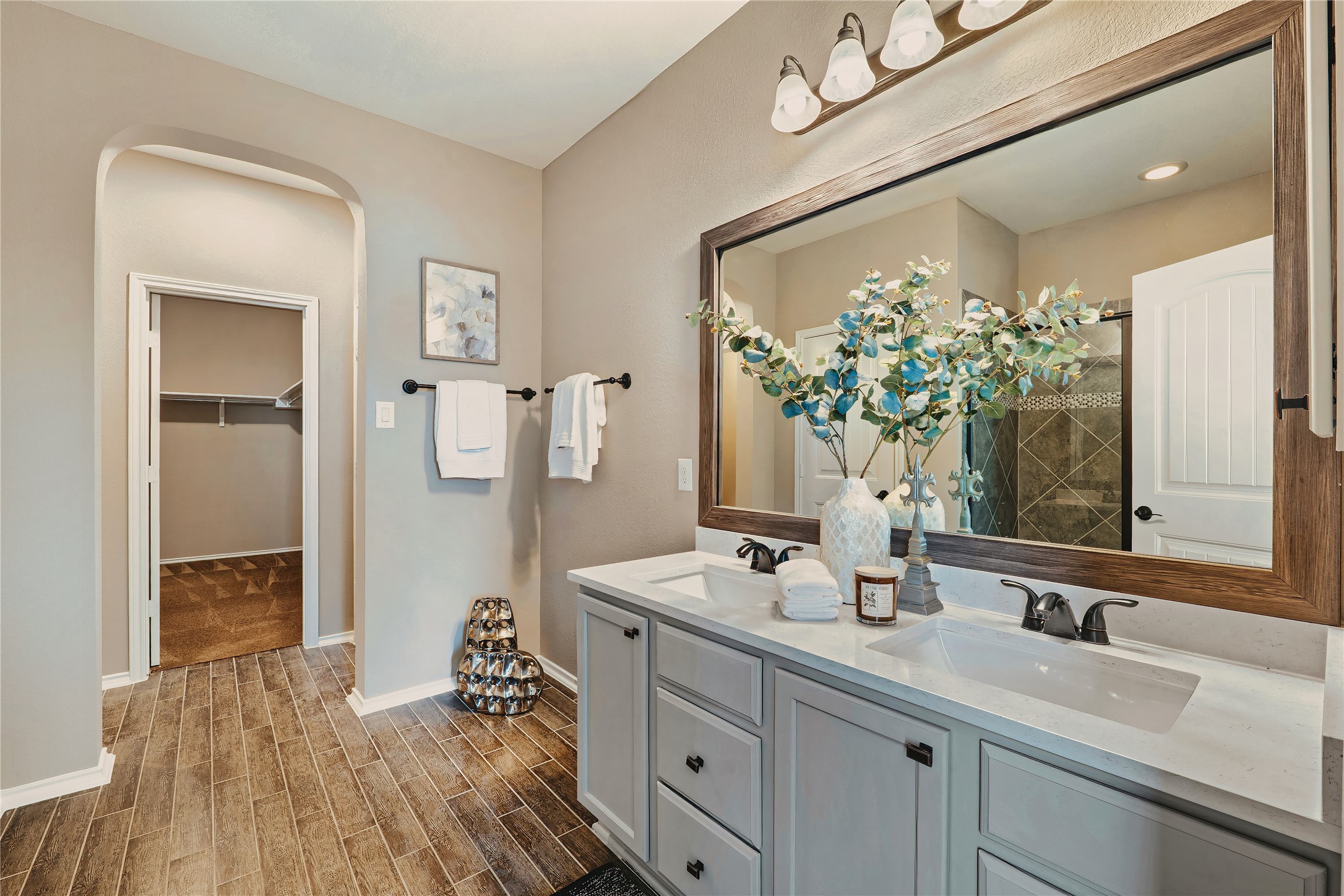 207 Telluride Drive Georgetown, TX 78626 - Photo 16 of 40 Main bathroom featuring a spacious closet, wood tile finish floors, and double vanity with linen closed.