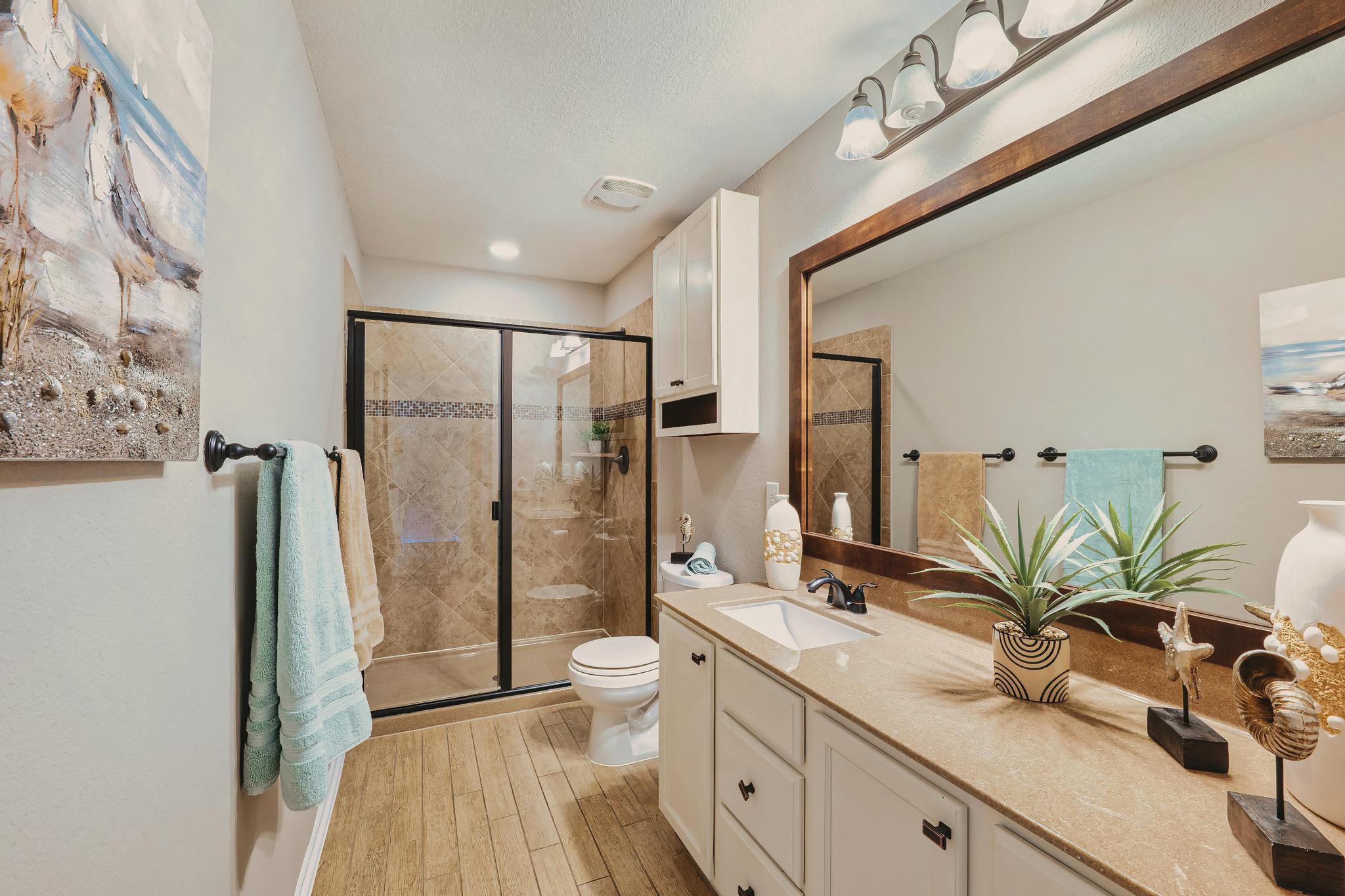 207 Telluride Drive Georgetown, TX 78626 - Photo 32 of 40 Second floor Full bath featuring a shower stall, vanity, and light wood-style floors