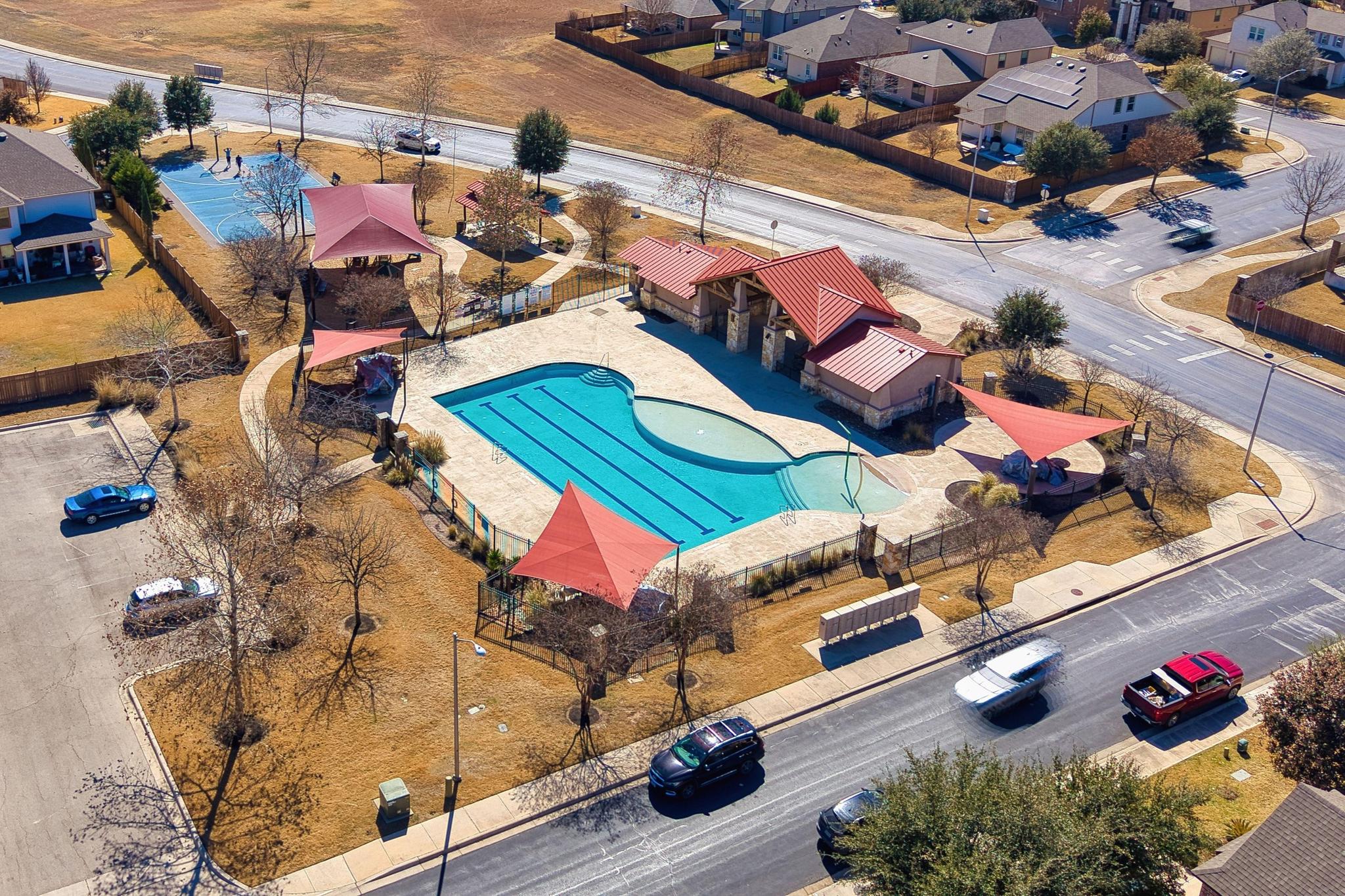 207 Telluride Drive Georgetown, TX 78626 - Photo 37 of 40 Aerial perspective of the community pool and basket ball court and spacious parking spaces.
