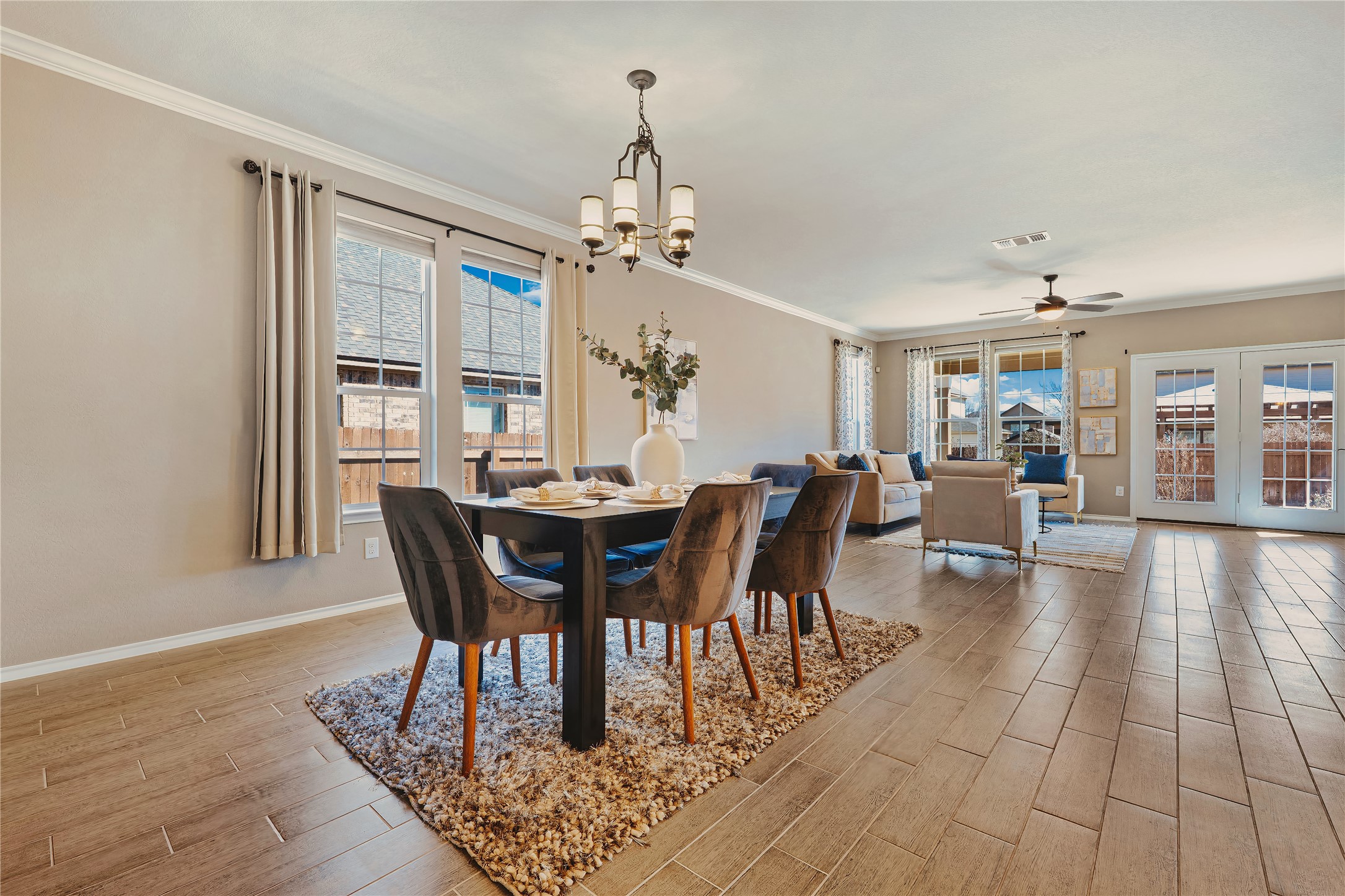207 Telluride Drive Georgetown, TX 78626 - Photo 7 of 40 Dining area featuring tile-wood finish floors, crown molding, a chandelier. Plenty of natural light