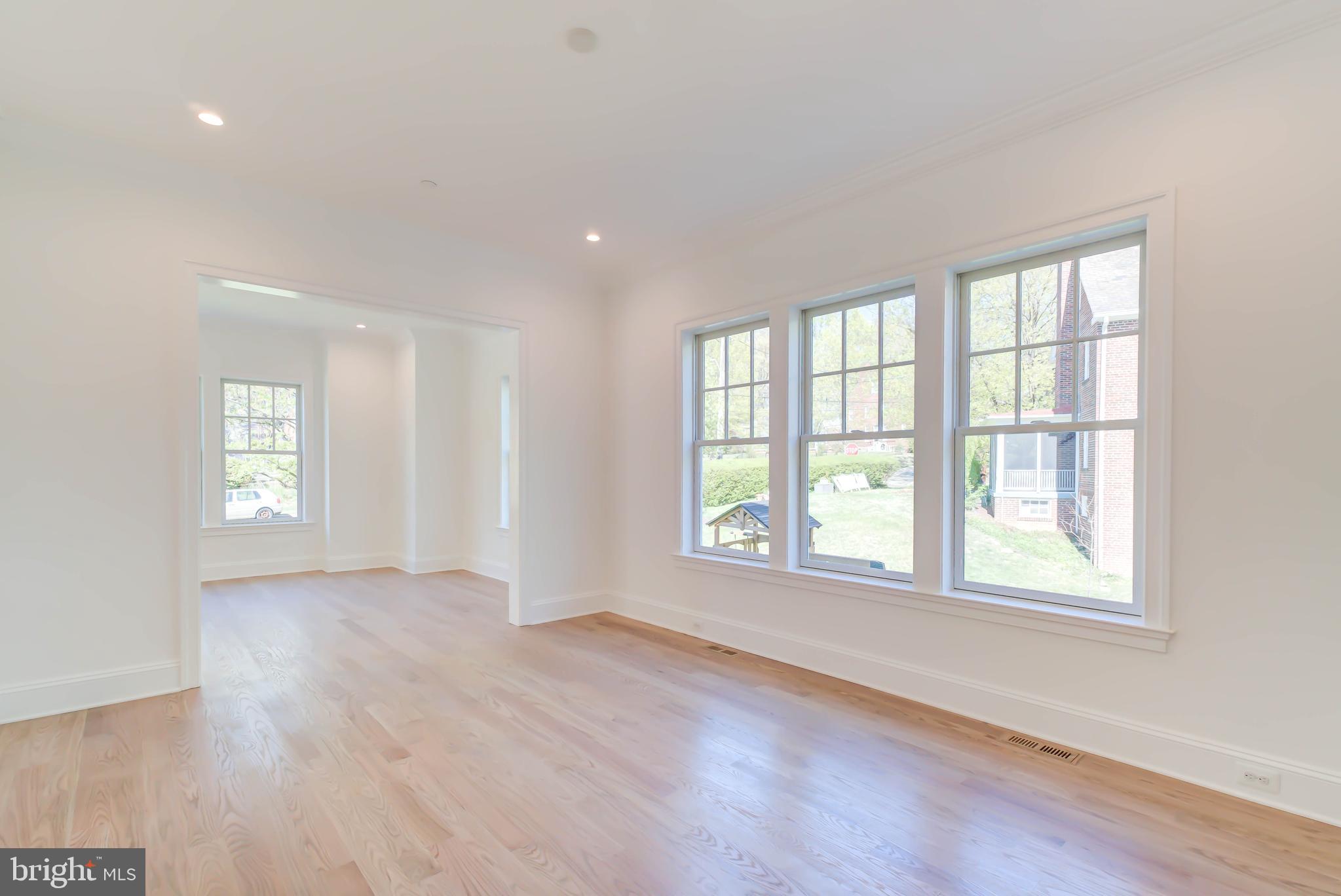 3118 Patterson Street Northwest Washington, DC 20015 - Photo 12 of 79 an empty room with wooden floor and windows