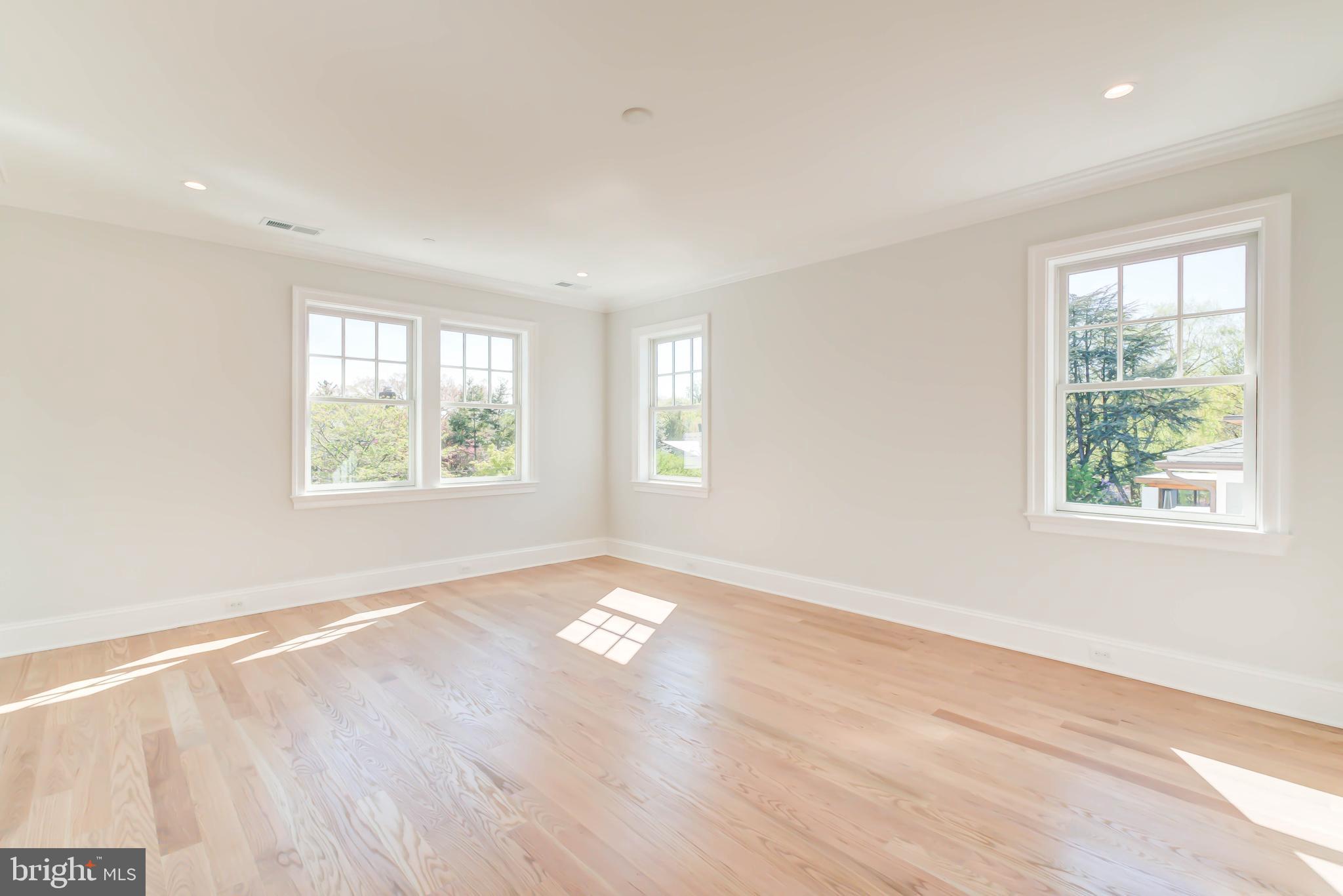 3118 Patterson Street Northwest Washington, DC 20015 - Photo 34 of 79 an empty room with wooden floor and windows