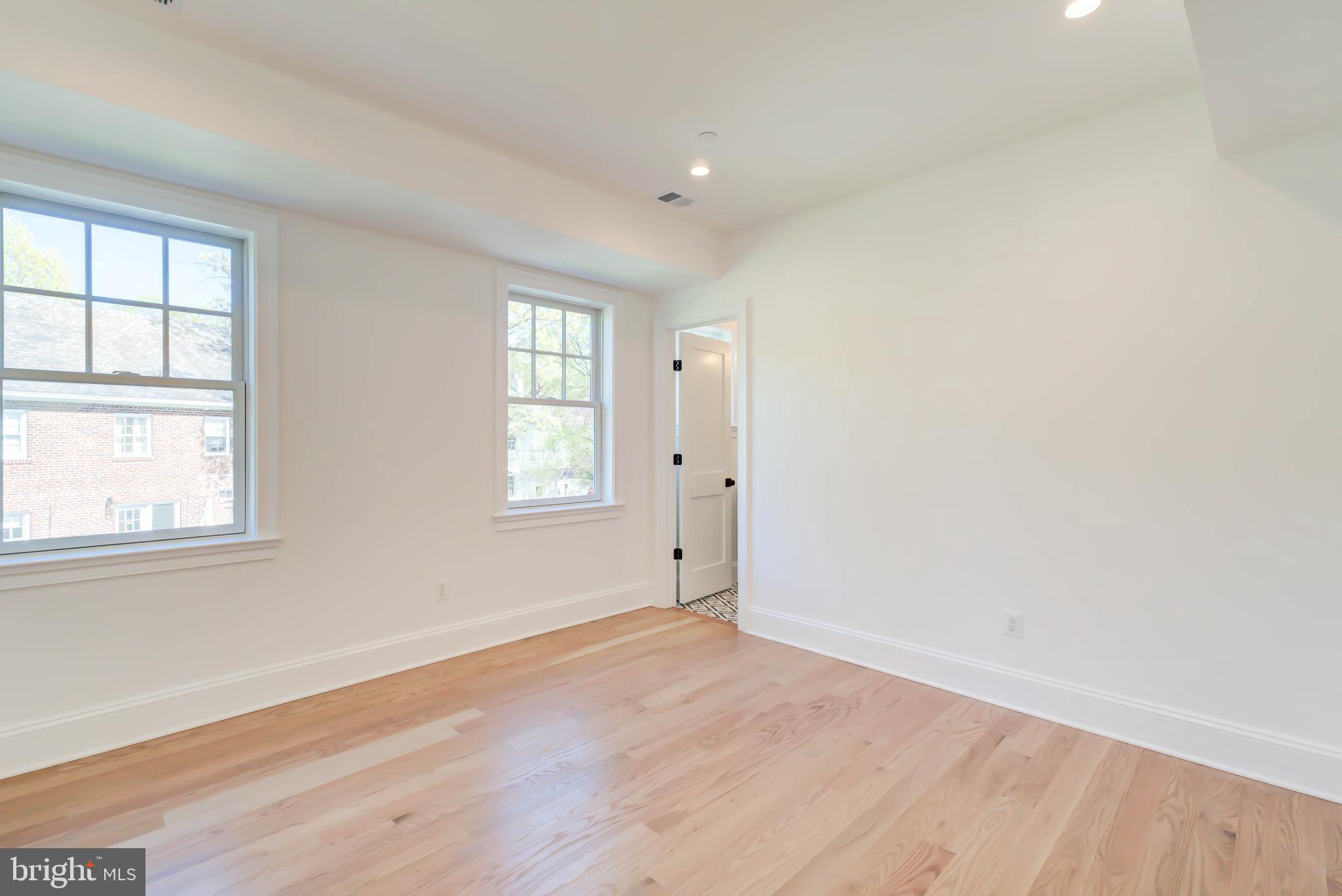 3118 Patterson Street Northwest Washington, DC 20015 - Photo 44 of 79 an empty room with wooden floor and windows