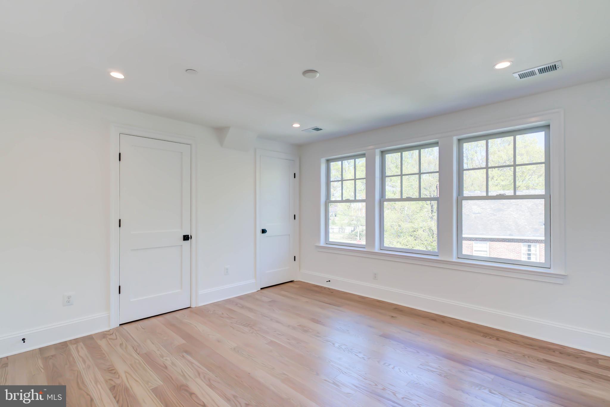 3118 Patterson Street Northwest Washington, DC 20015 - Photo 52 of 79 an empty room with wooden floor and windows