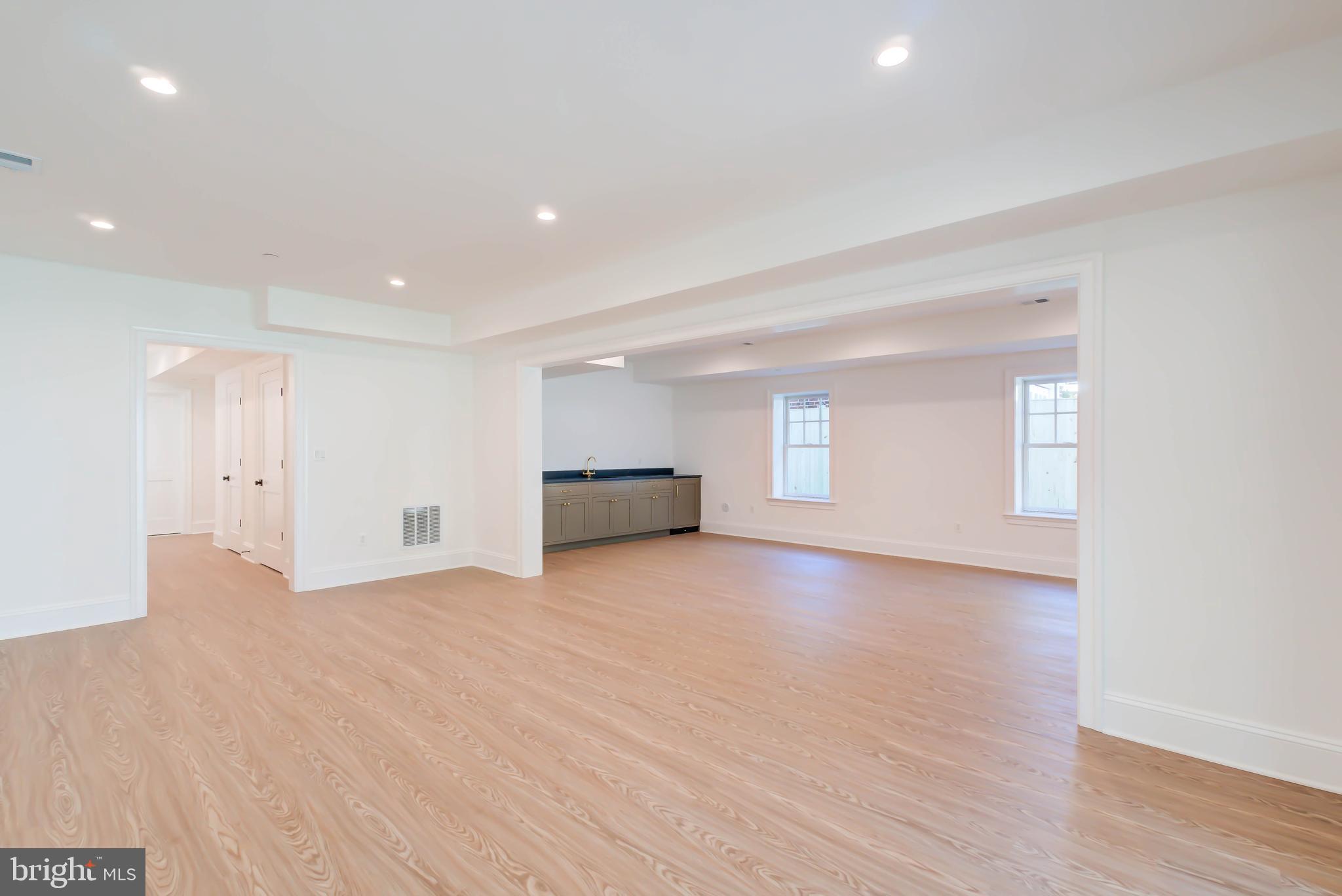 3118 Patterson Street Northwest Washington, DC 20015 - Photo 61 of 79 a view of empty room with wooden floor and kitchen