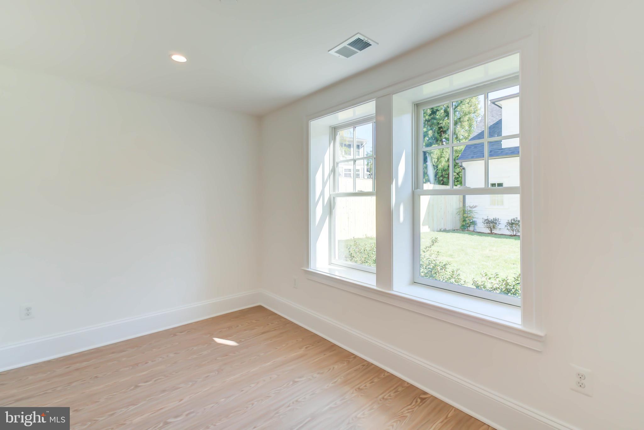 3118 Patterson Street Northwest Washington, DC 20015 - Photo 65 of 79 an empty room with wooden floor and windows