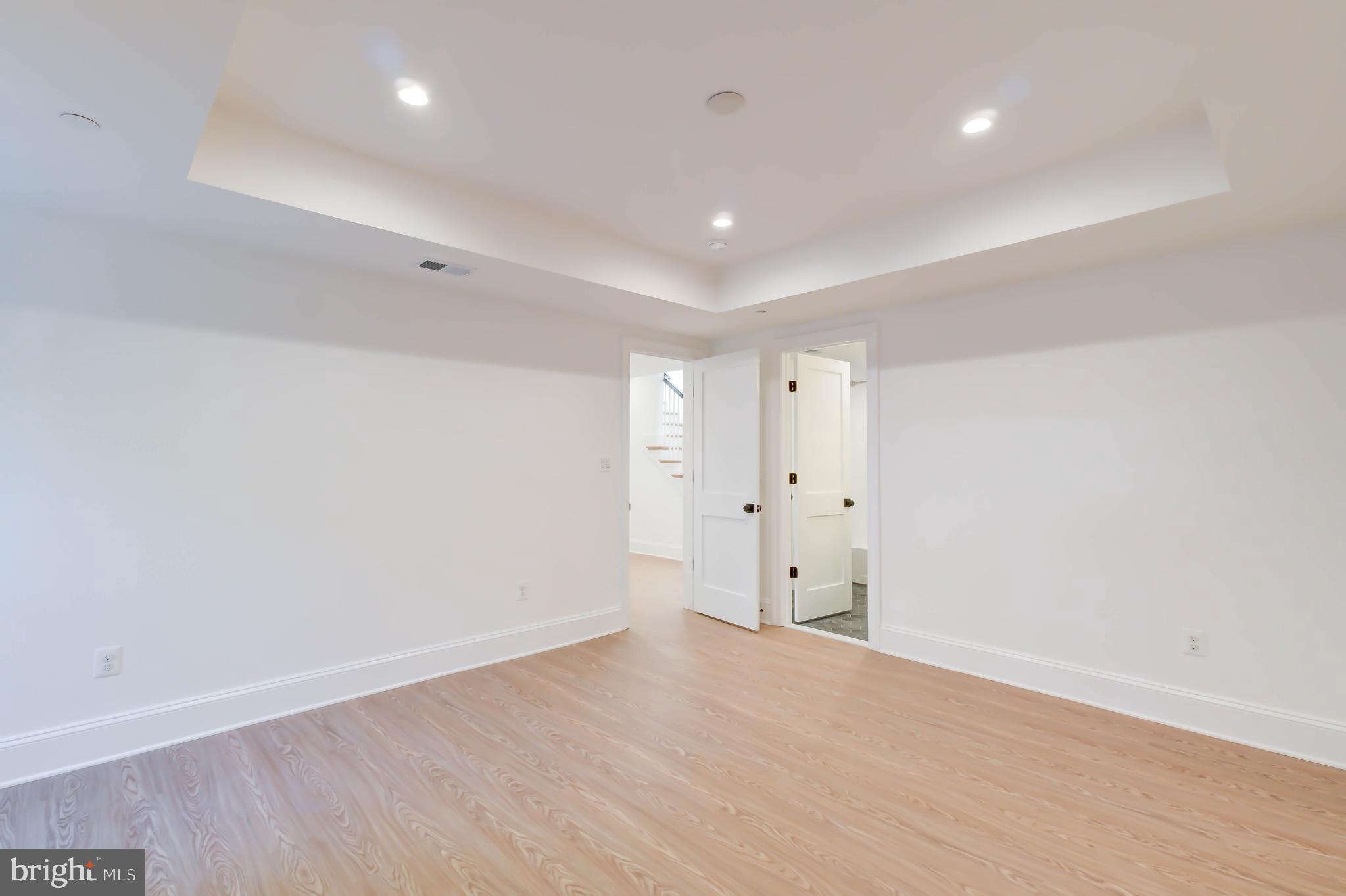 3118 Patterson Street Northwest Washington, DC 20015 - Photo 67 of 79 an empty room with wooden floor and windows