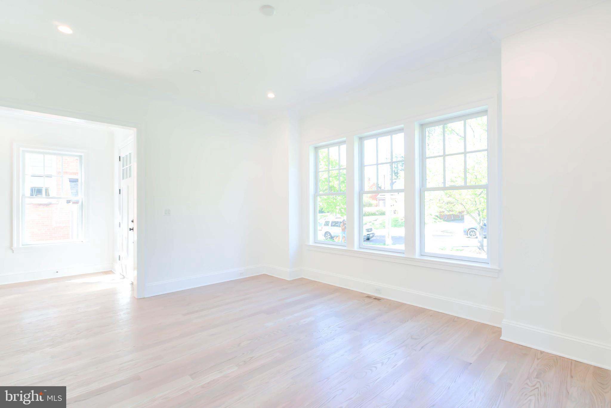3118 Patterson Street Northwest Washington, DC 20015 - Photo 10 of 79 an empty room with wooden floor and windows