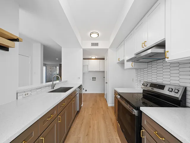 a kitchen with a sink and a stove