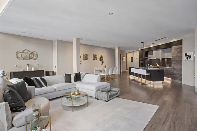 a living room with furniture and view of kitchen