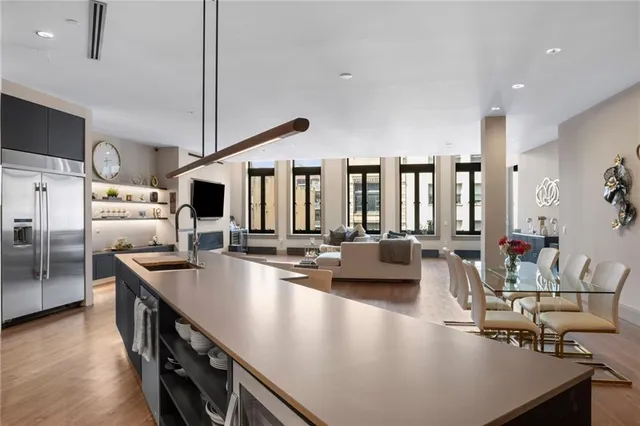 a kitchen with stainless steel appliances granite countertop a sink a stove and a refrigerator