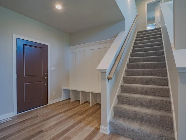 a view of entryway and hall with wooden floor